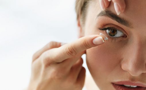 Contact Lens For Vision. Closeup Of Female Face With Applying Contact Lens On Her Brown Eyes. Beautiful Woman Putting Eye Lenses With Hands. Opthalmology Medicine And Health. High Resolution