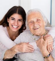 Portrait Of Happy Grandmother And Daughter Embracing Each Other At Home
