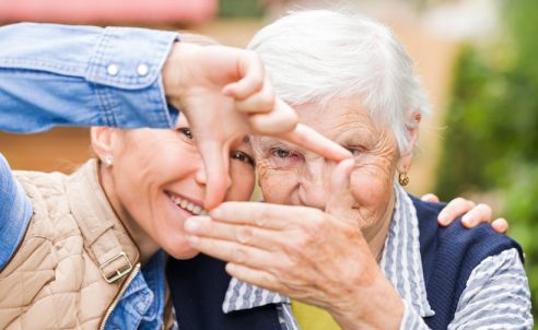 Photo of elderly woman with grandchild having funny